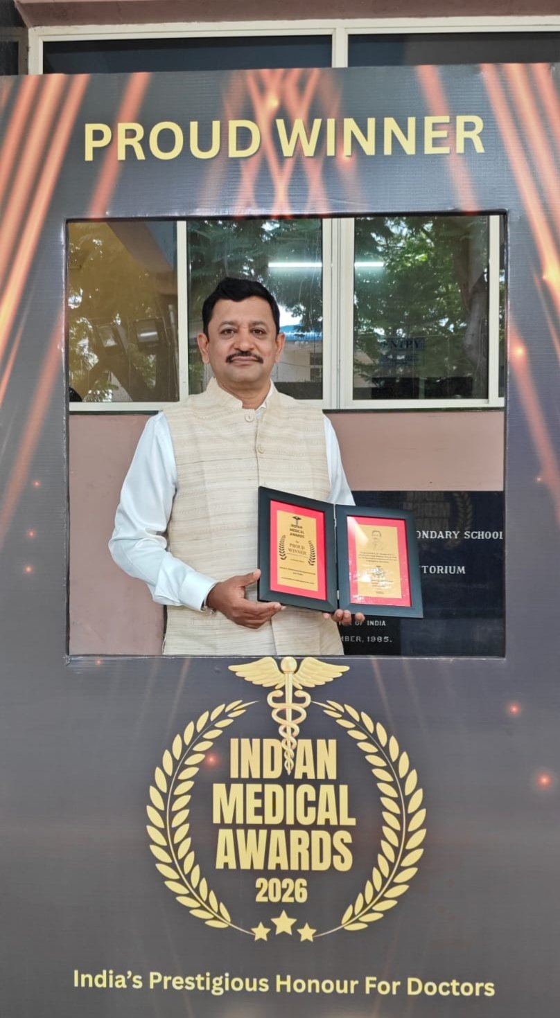 Dr. Diwakar holding his recognition at the Indian Medical Awards 2026